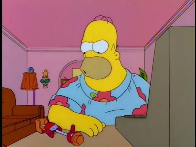 Homer Simpson, angrily looking at the fallen drinking bird.